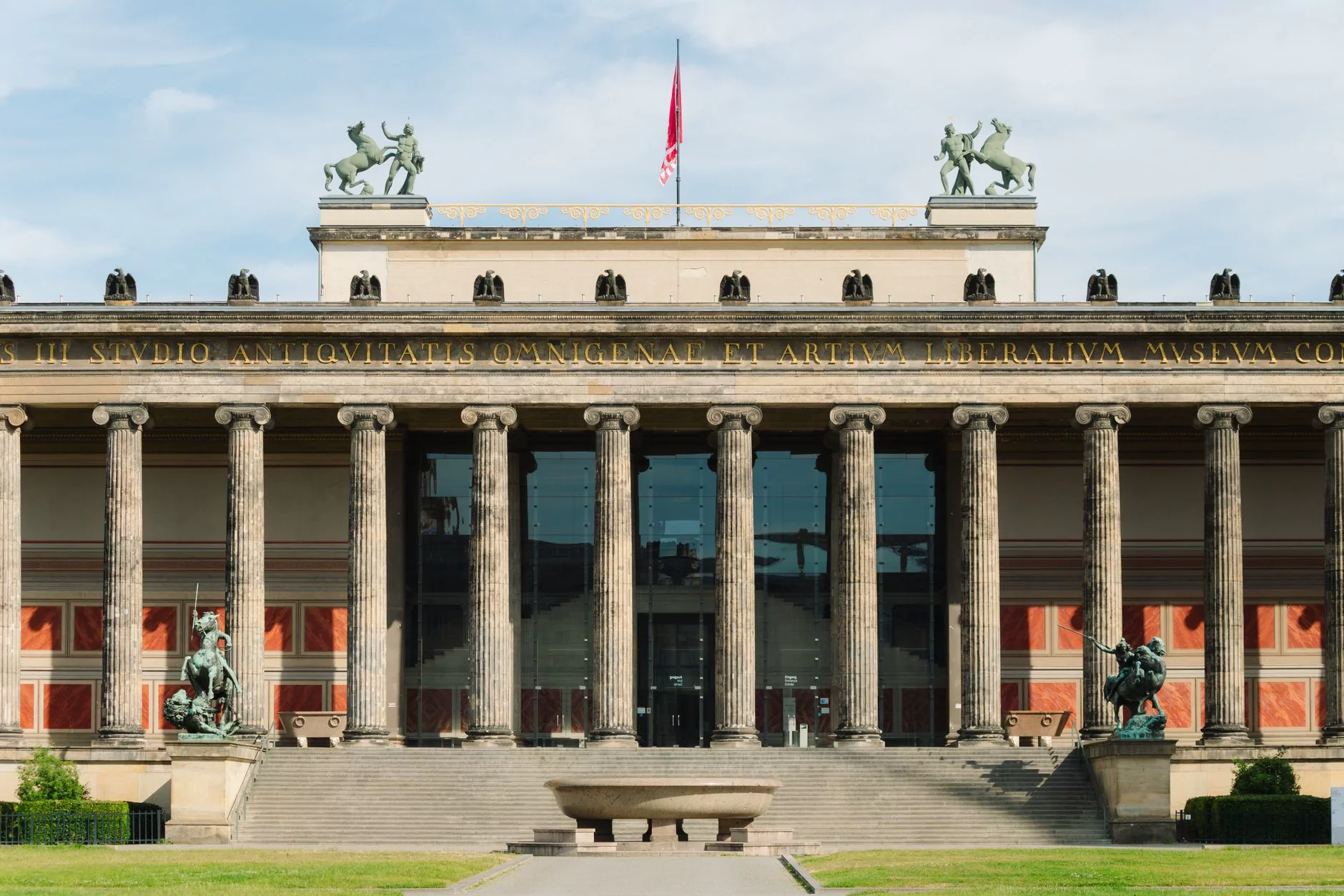 The Altes Museum in Berlin, known for its neoclassical architecture, under a clear sky.